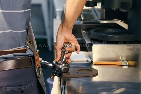 Sử dụng tamper nén cà phê với lực vừa đủ để chiết xuất Espresso đúng chuẩn Ý